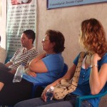 Right-to-left: Christiane, Celeste, and Saul at a community meeting