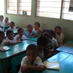 The kids have to sit 3 per desk